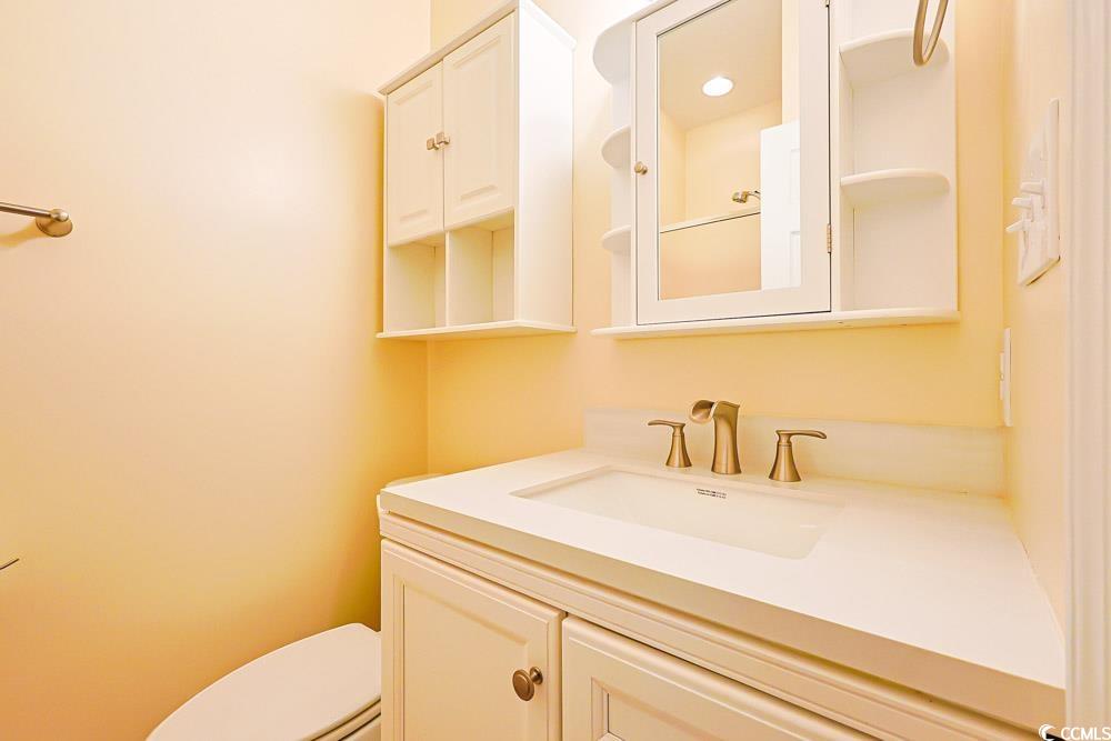 401 Pipers Lane, Unit 401 Myrtle Beach, SC 29575 - Photo 20 of 40 Half bath with vanity and toilet