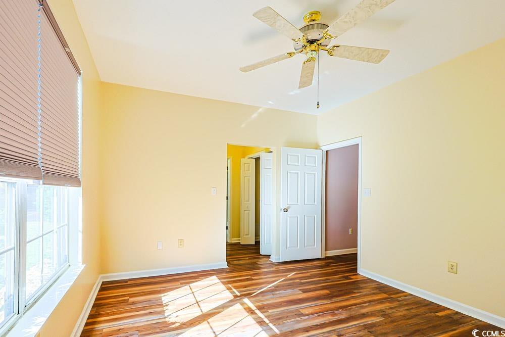 401 Pipers Lane, Unit 401 Myrtle Beach, SC 29575 - Photo 21 of 40 Unfurnished bedroom with wood finished floors and ceiling fan