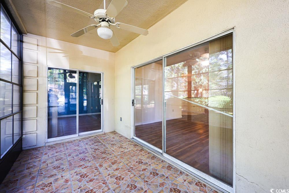 401 Pipers Lane, Unit 401 Myrtle Beach, SC 29575 - Photo 32 of 40 Unfurnished sunroom featuring a ceiling fan