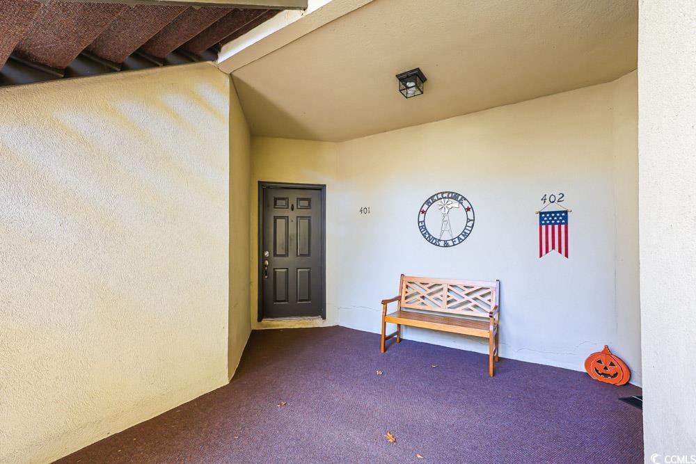 401 Pipers Lane, Unit 401 Myrtle Beach, SC 29575 - Photo 36 of 40 Doorway to property with stucco siding