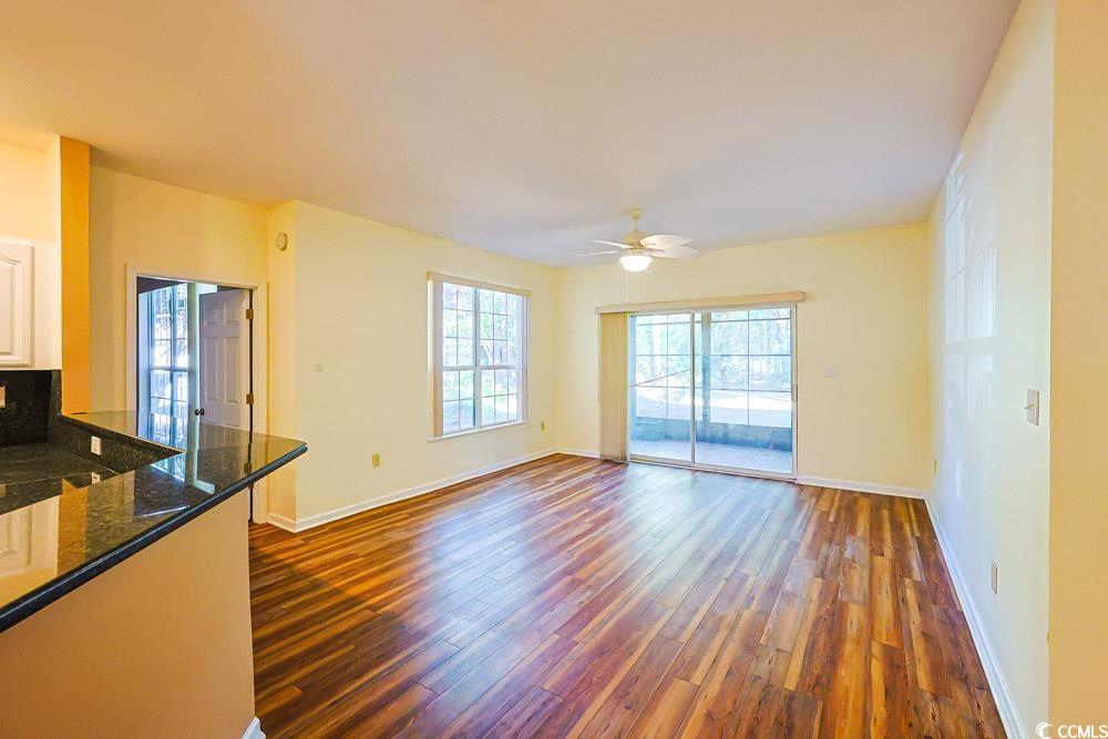401 Pipers Lane, Unit 401 Myrtle Beach, SC 29575 - Photo 38 of 40 Kitchen featuring dark wood-style flooring, plenty of natural light, ceiling fan, and open floor plan