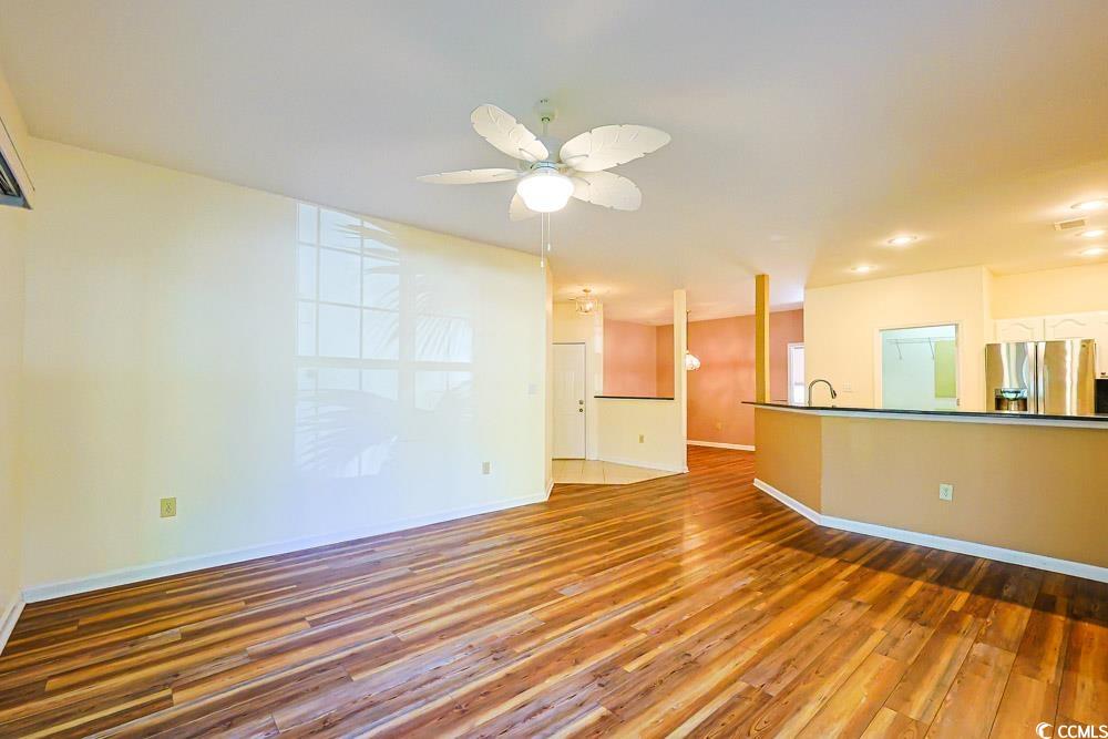 401 Pipers Lane, Unit 401 Myrtle Beach, SC 29575 - Photo 5 of 40 Unfurnished living room featuring light wood-style flooring and ceiling fan