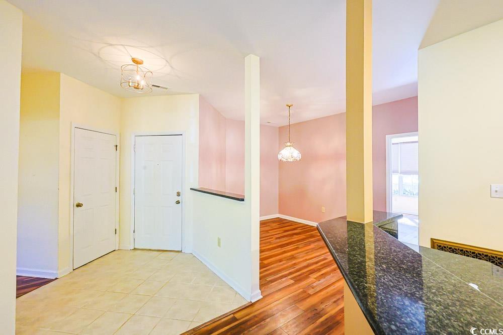 401 Pipers Lane, Unit 401 Myrtle Beach, SC 29575 - Photo 6 of 40 Foyer with a chandelier and light wood finished floors