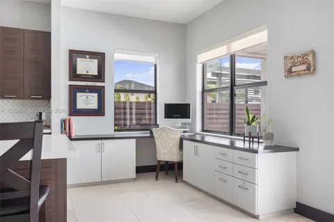 a room with furniture a large window and potted plants