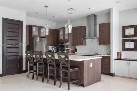 a kitchen with kitchen island a counter top space appliances and cabinets