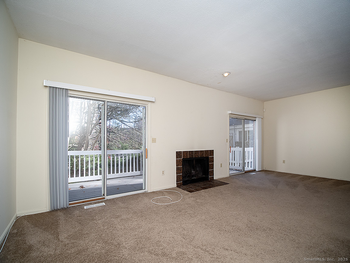 3989 Park Avenue, Unit 3989 Fairfield, CT 06825 - Photo 14 of 37 a view of an empty room with a fireplace and a window