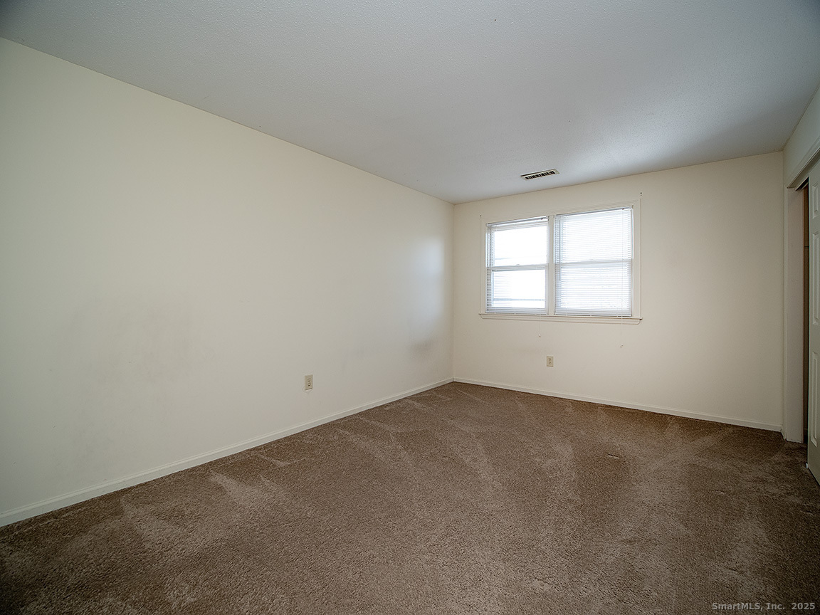 3989 Park Avenue, Unit 3989 Fairfield, CT 06825 - Photo 18 of 37 an empty room with a window