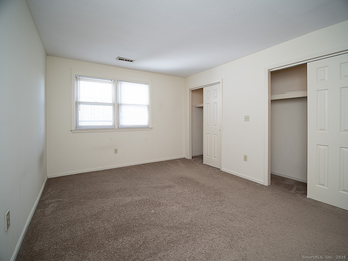 3989 Park Avenue, Unit 3989 Fairfield, CT 06825 - Photo 19 of 37 an empty room with windows and closet