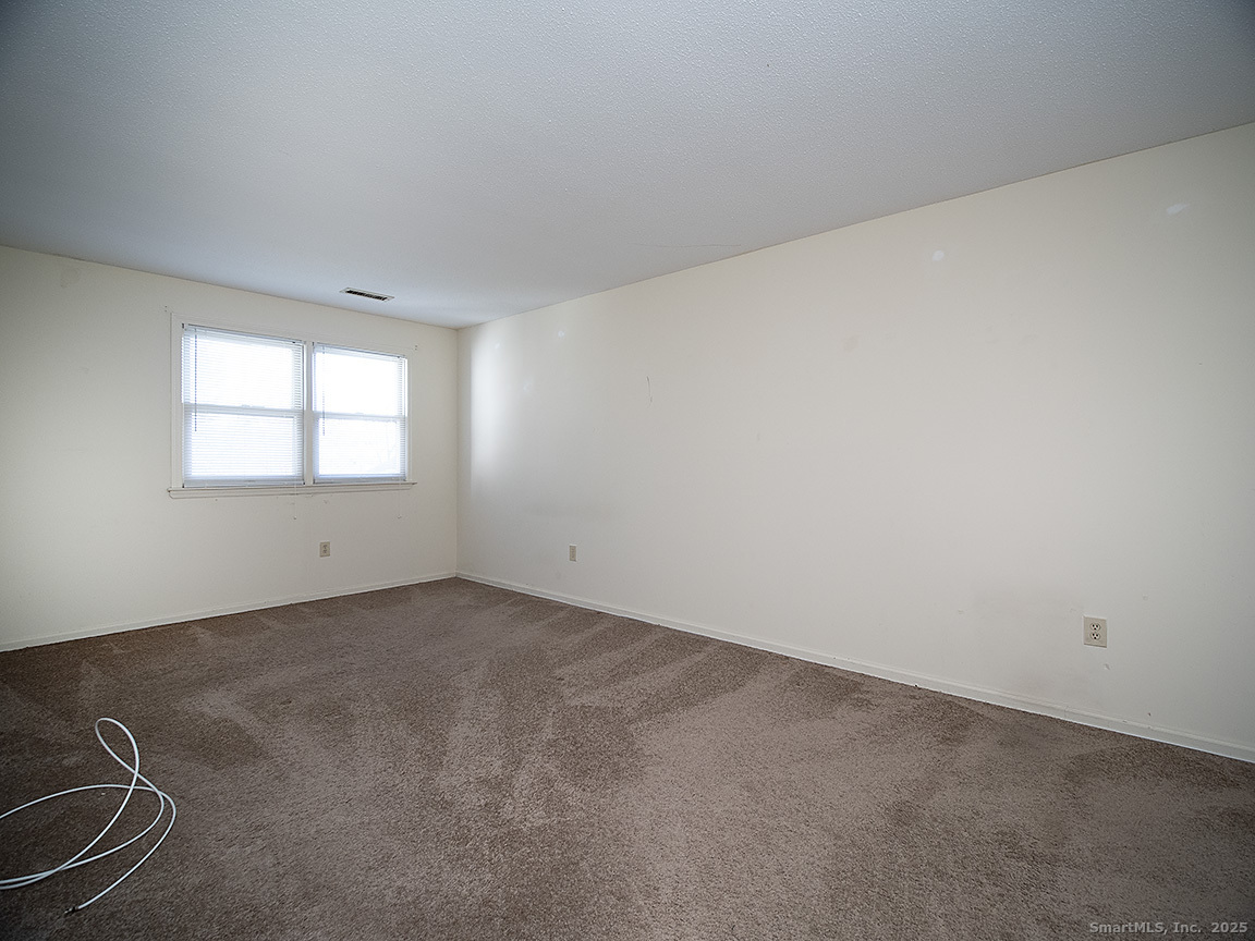 3989 Park Avenue, Unit 3989 Fairfield, CT 06825 - Photo 21 of 37 an empty room with windows