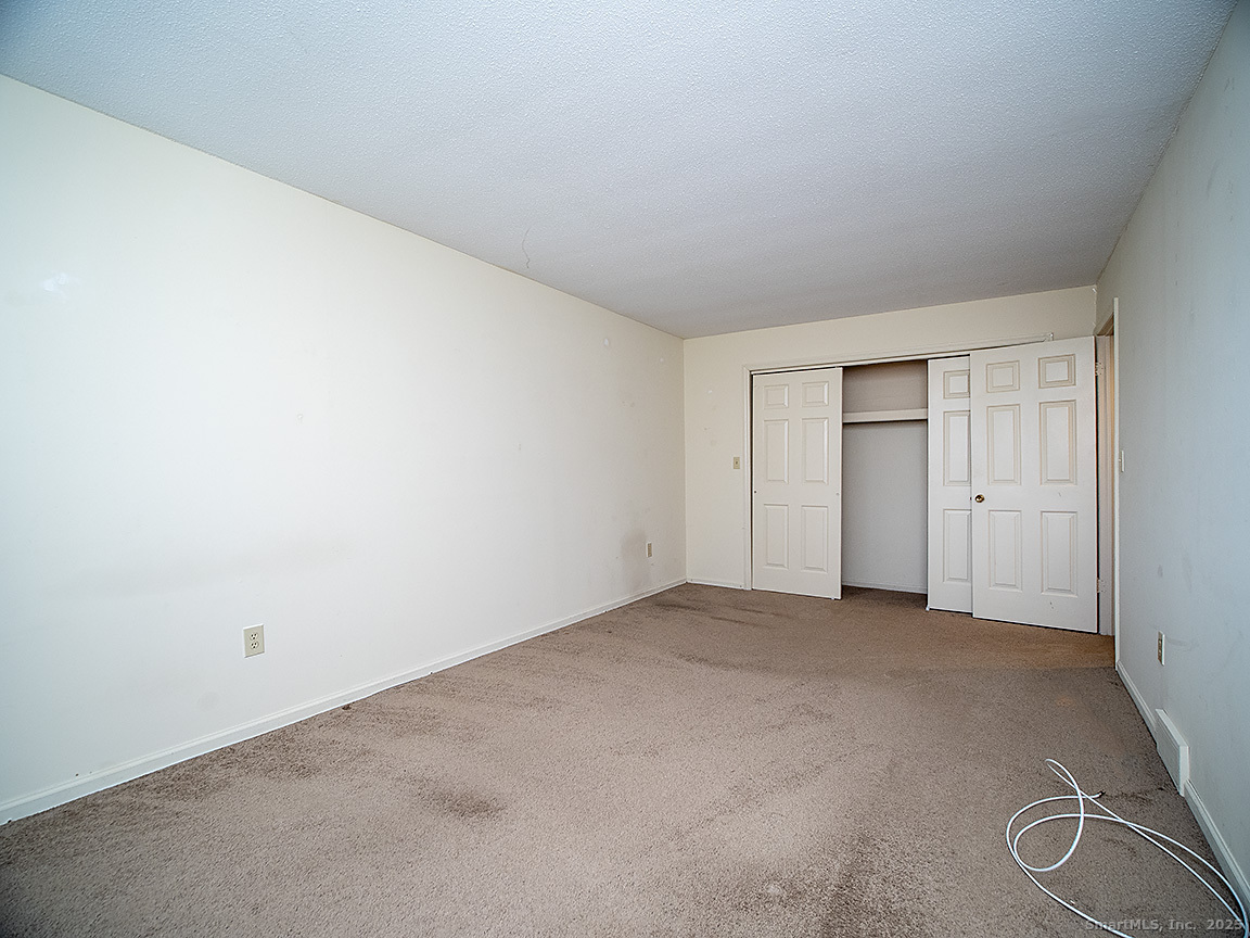 3989 Park Avenue, Unit 3989 Fairfield, CT 06825 - Photo 23 of 37 an empty room with windows