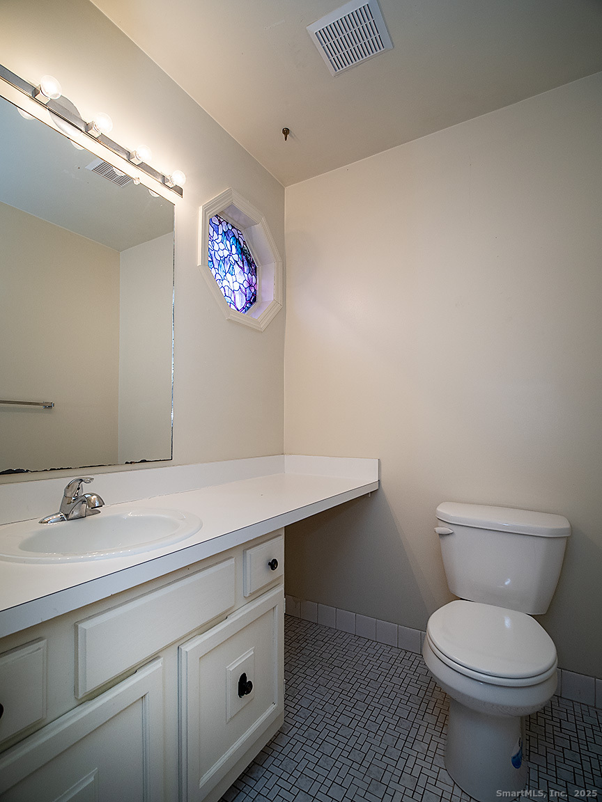 3989 Park Avenue, Unit 3989 Fairfield, CT 06825 - Photo 31 of 37 a bathroom with a toilet sink and vanity
