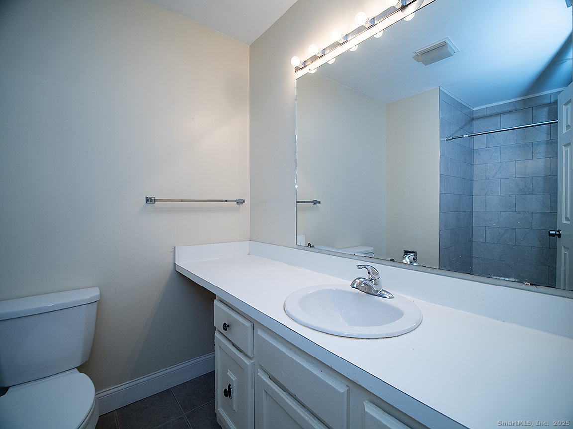 3989 Park Avenue, Unit 3989 Fairfield, CT 06825 - Photo 33 of 37 a bathroom with a sink toilet and a mirror