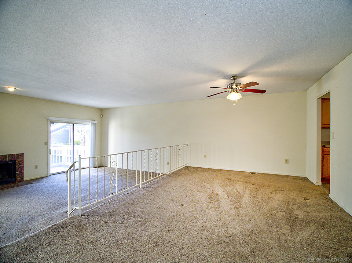3989 Park Avenue, Unit 3989 Fairfield, CT 06825 - Photo 10 of 37 an empty room with windows and chandelier fan
