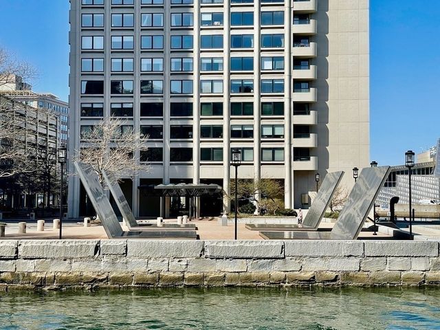 a living room with furniture fireplace and a large window