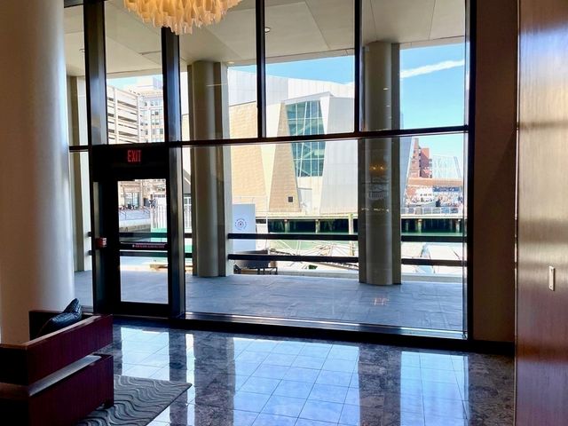 a view of a swimming pool with an outdoor seating a yard and a tree
