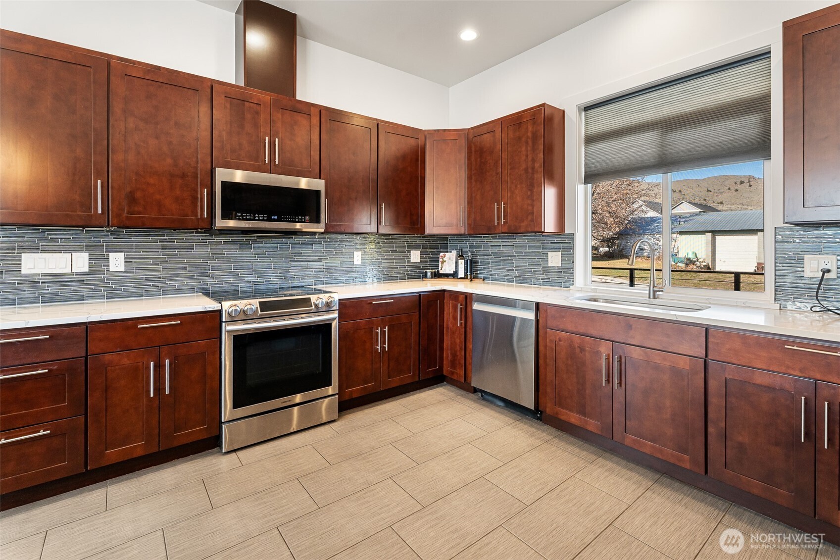 1038 Crest Loop Entiat, WA 98822 - Photo 14 of 40 a kitchen with stainless steel appliances granite countertop wooden cabinets a sink and dishwasher