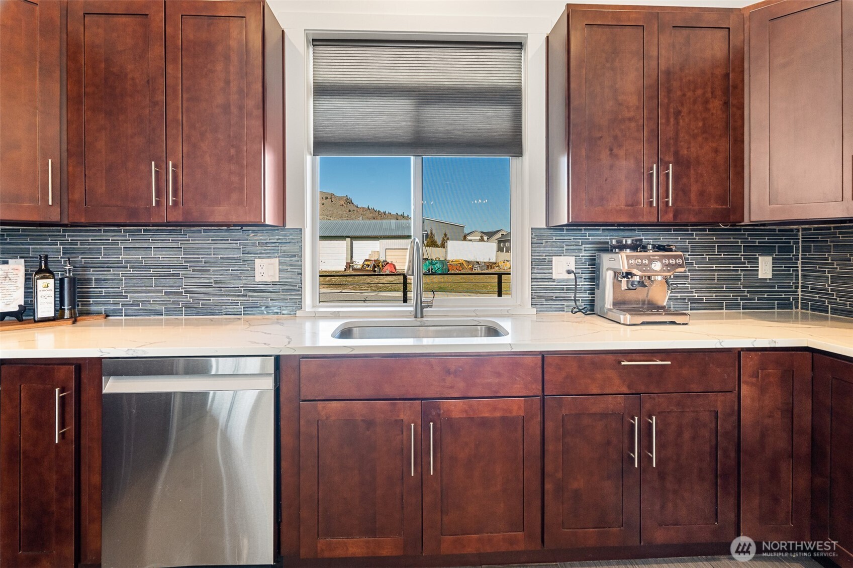 1038 Crest Loop Entiat, WA 98822 - Photo 15 of 40 a kitchen with stainless steel appliances granite countertop wooden cabinets a sink and dishwasher