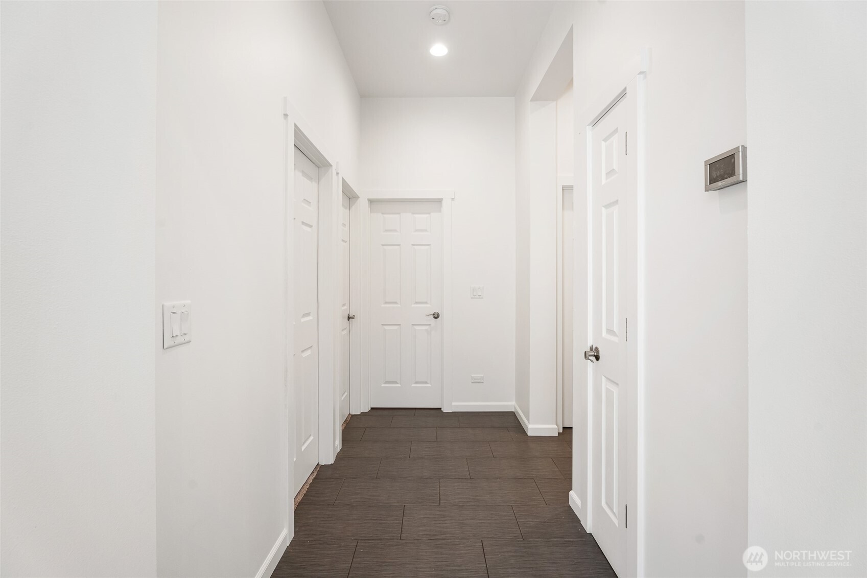 1038 Crest Loop Entiat, WA 98822 - Photo 16 of 40 a view of a hallway with wooden floor