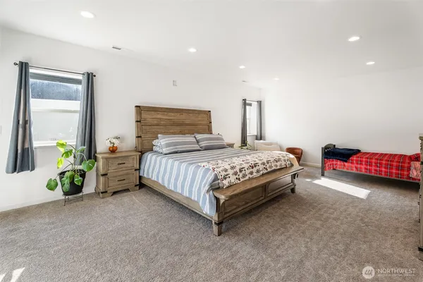 a bedroom with a bed and a television