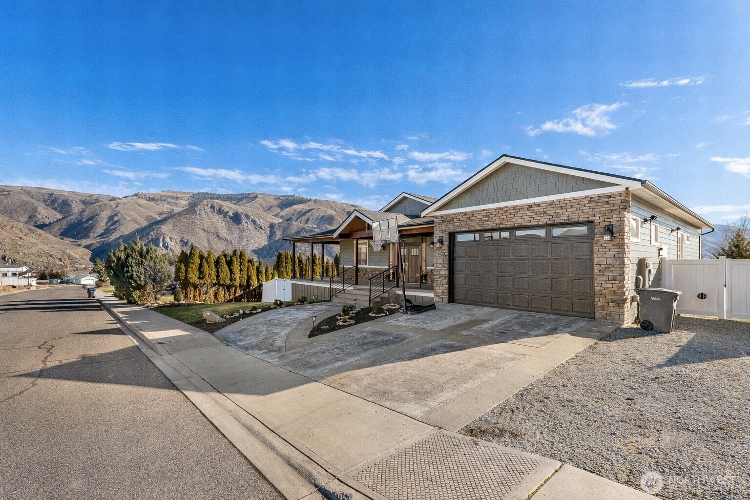 1038 Crest Loop Entiat, WA 98822 - Photo 3 of 40 a front view of a house with a yard and garage
