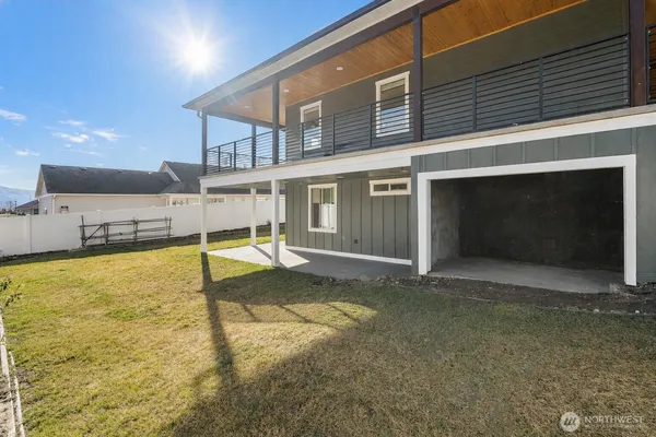 a view of house with backyard and deck