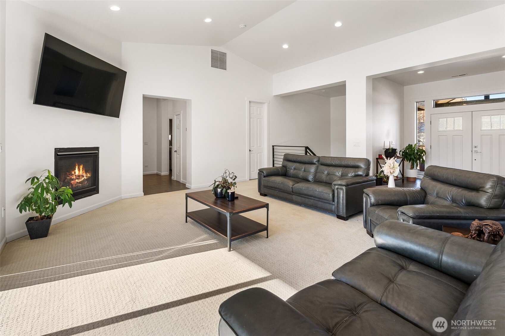1038 Crest Loop Entiat, WA 98822 - Photo 8 of 40 a living room with furniture a fireplace and a flat screen tv