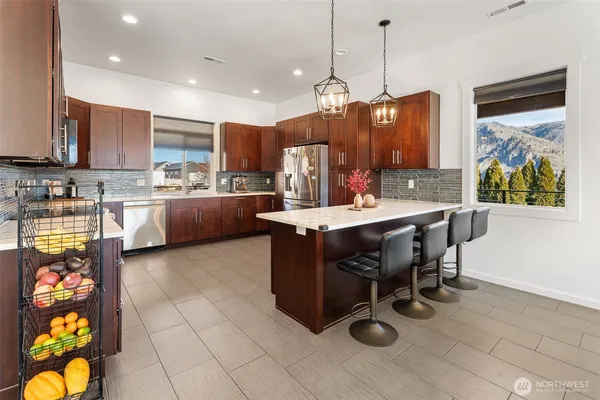a kitchen with granite countertop a sink appliances and cabinets