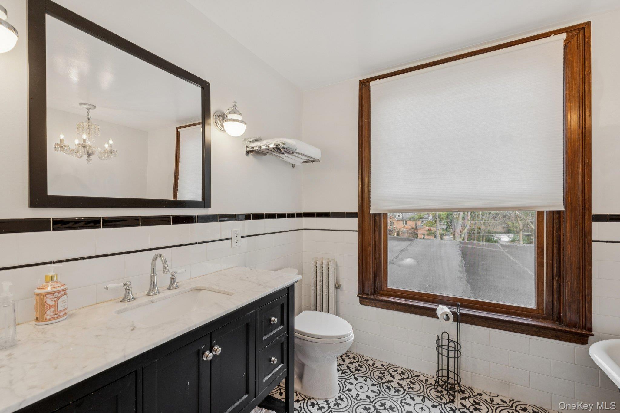 397 Split Rock Road Syosset, NY 11791 - Photo 26 of 29 a bathroom with a granite countertop sink toilet and a mirror