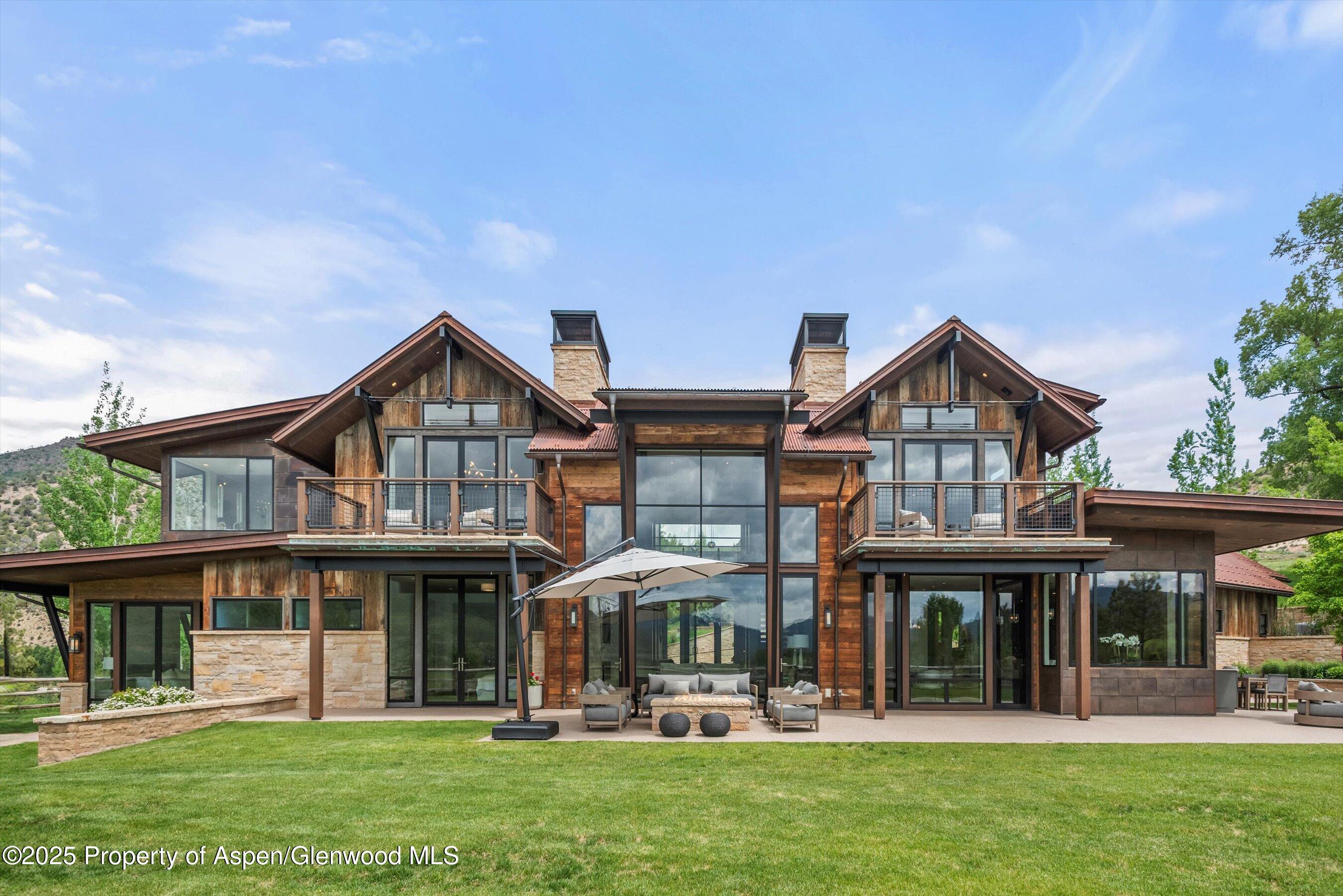 31 Aspen Valley Ranch Road Woody Creek, CO 81656 - Photo 2 of 52 a front view of a house with a yard
