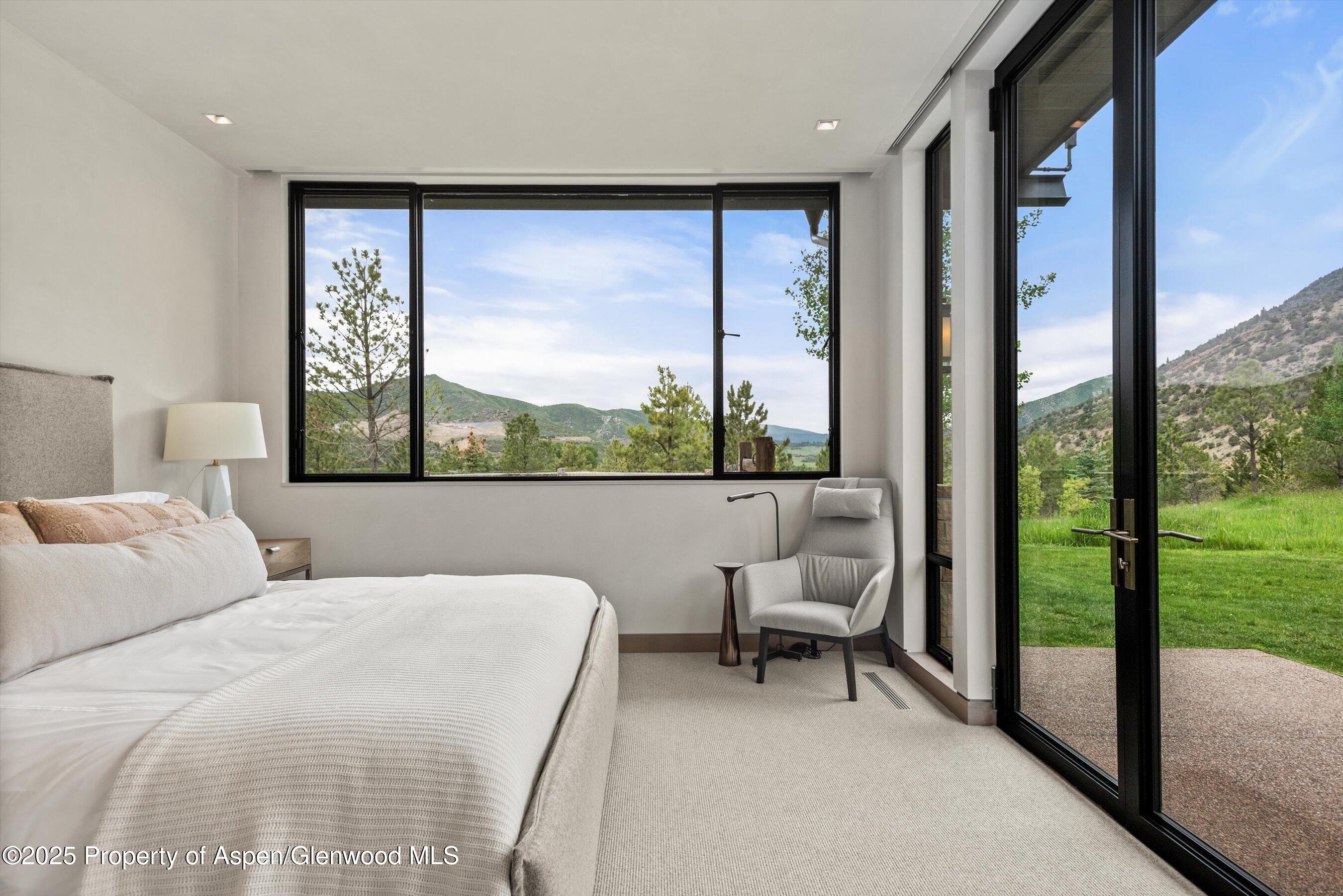 31 Aspen Valley Ranch Road Woody Creek, CO 81656 - Photo 29 of 52 a bedroom with a bed and a view of balcony