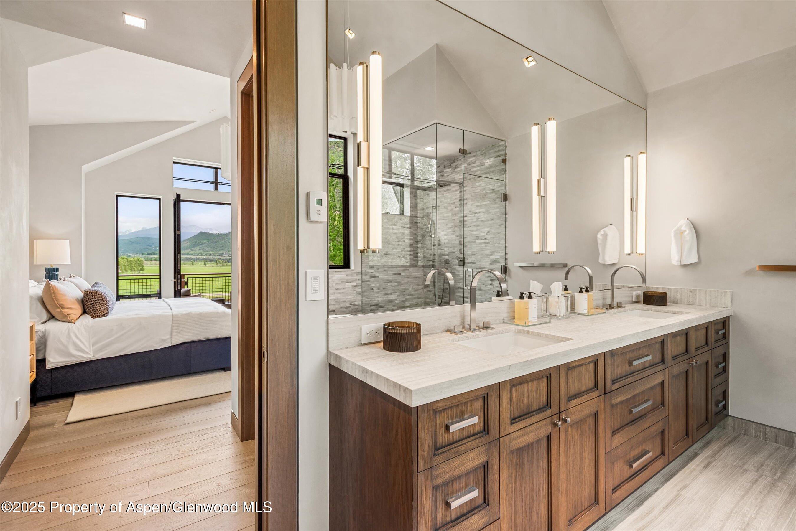 31 Aspen Valley Ranch Road Woody Creek, CO 81656 - Photo 34 of 52 a en suite bathroom with a sink double vanity and a mirror