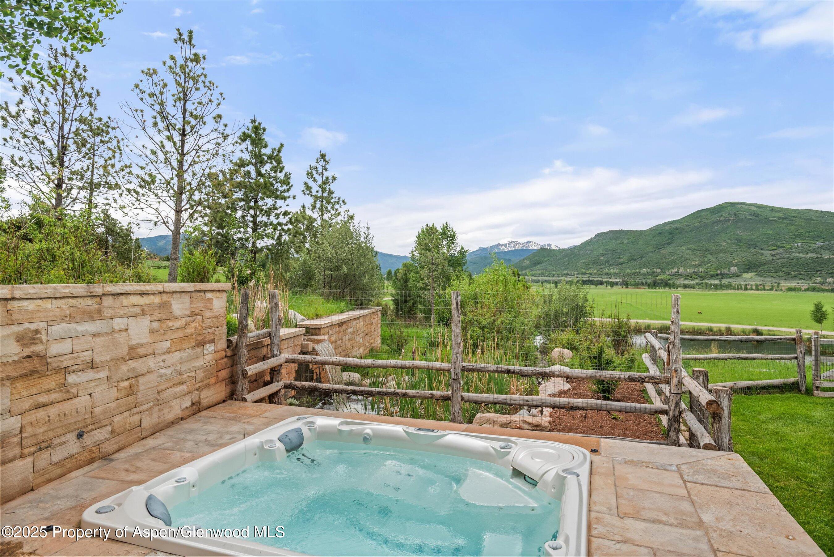 31 Aspen Valley Ranch Road Woody Creek, CO 81656 - Photo 45 of 52 a view of a swimming pool with a patio and mountain view