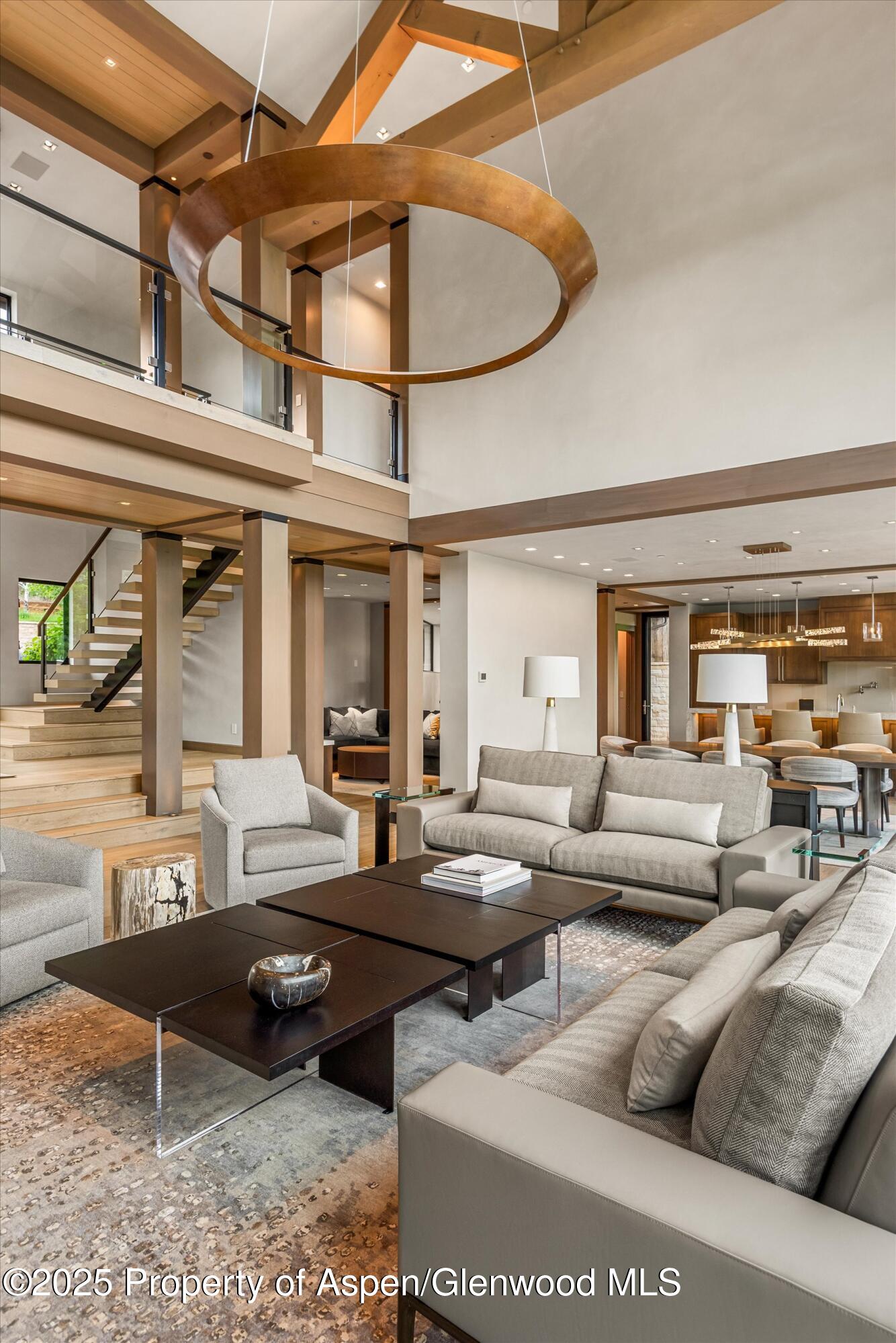 31 Aspen Valley Ranch Road Woody Creek, CO 81656 - Photo 6 of 52 a living room with furniture a rug and a chandelier