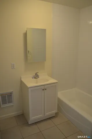 a bathroom with a sink a vanity and mirror