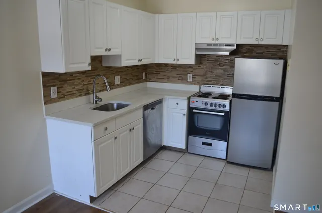 a kitchen with a sink stove and refrigerator