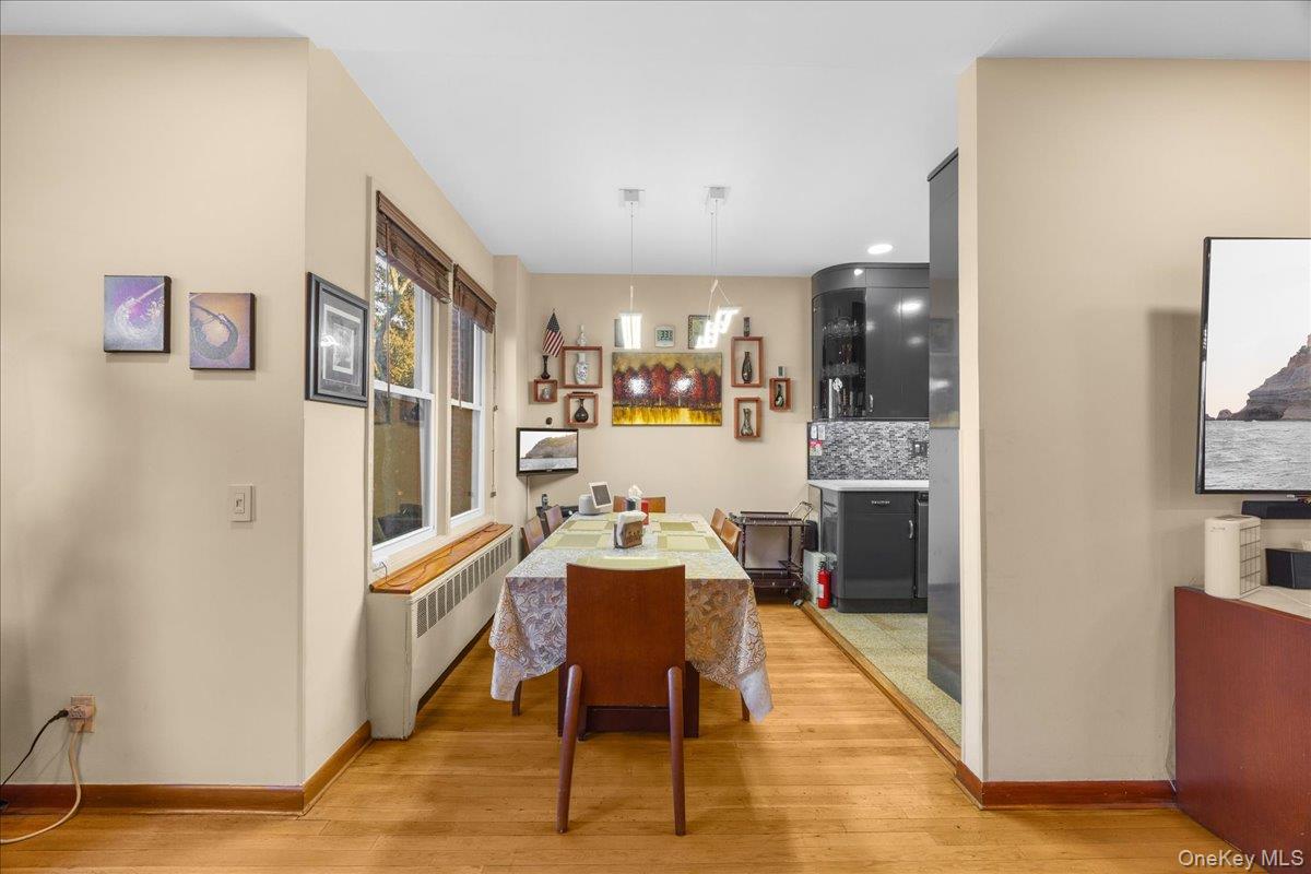 1015 Old Boston Post Road, Unit 2C Mamaroneck, NY 10543 - Photo 7 of 26 Dining area featuring radiator and light wood-style floors