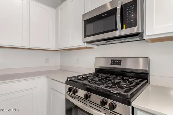 a stove top oven sitting inside of a kitchen
