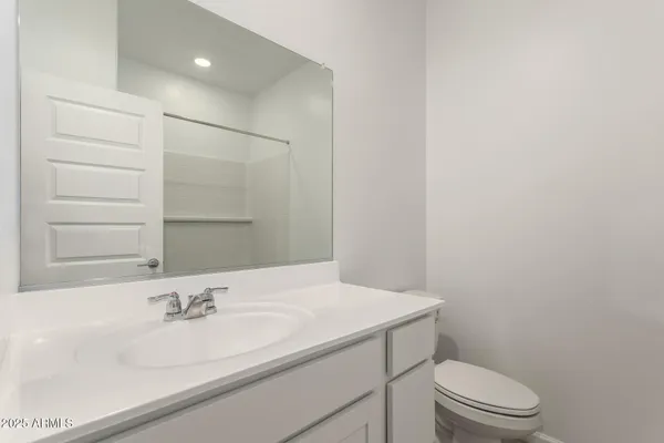 a bathroom with a sink a toilet and mirror