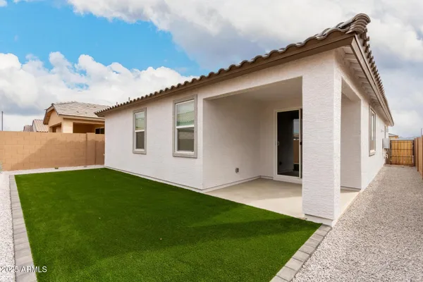 a backyard of a house with table and chairs