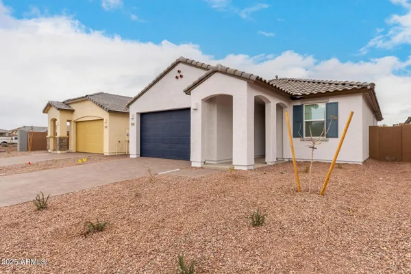 a view of a house with a backyard and garage