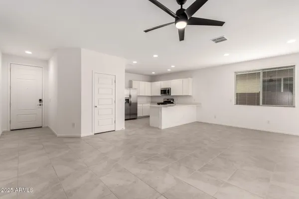 a view of kitchen with stainless steel appliances refrigerator oven and cabinets