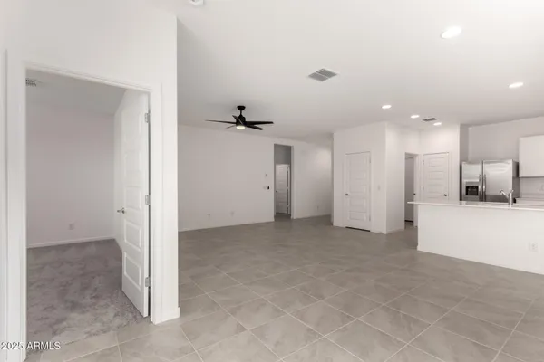 a view of a kitchen with a refrigerator and a sink