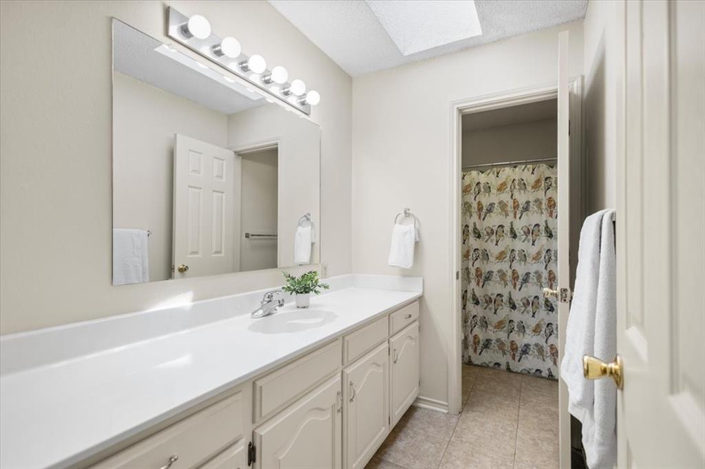 2824 Crestview Avenue Tyler, TX 75701 - Photo 21 of 39 a bathroom with a sink double vanity and a mirror