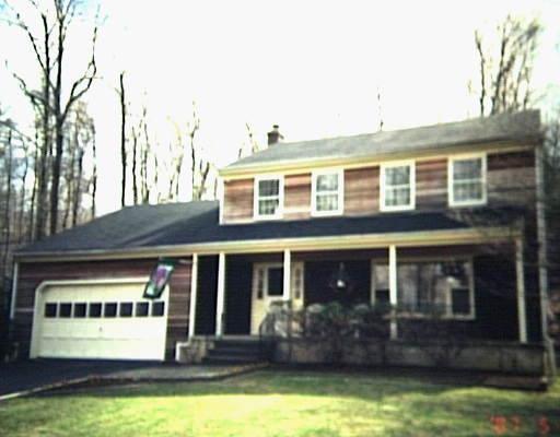a view of a house with swimming pool and a yard