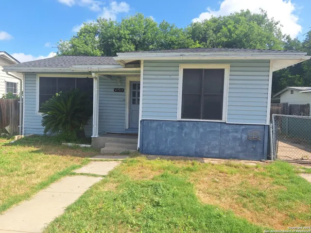 a view of a house with a yard and plants