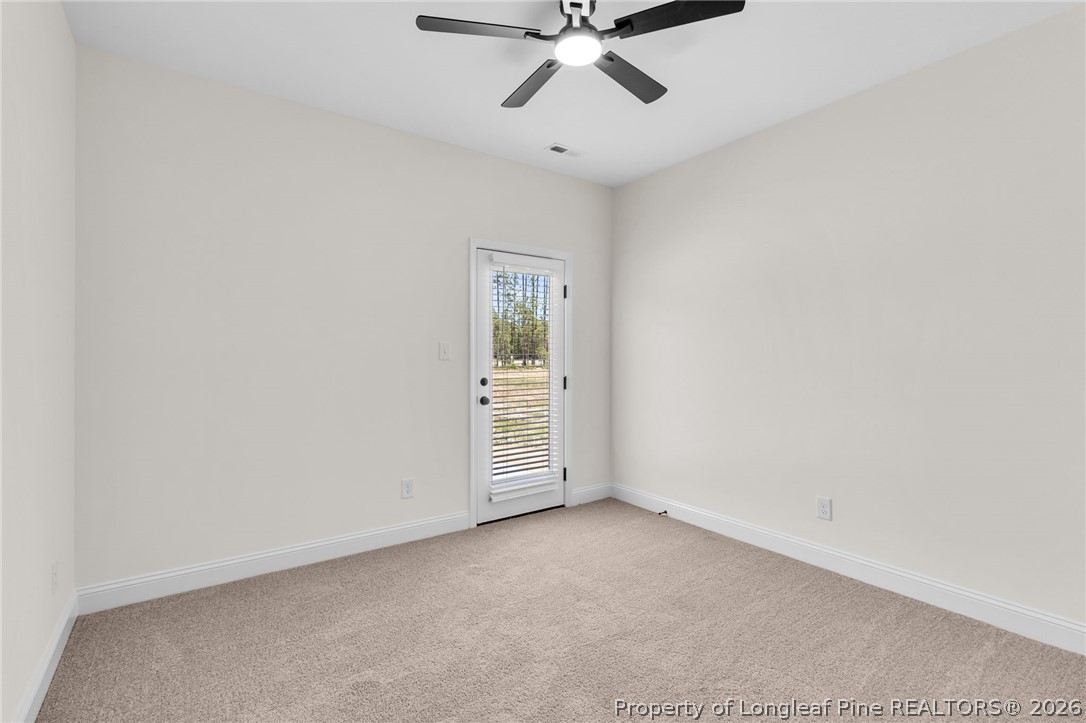 131 Merle Road Pinebluff, NC 28373 - Photo 28 of 33 an empty room with a ceiling fan and window