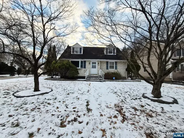 a front view of a house with a yard covered with snow in front of house