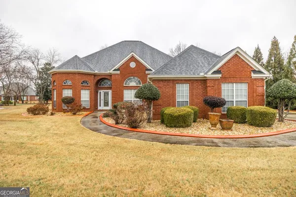 a front view of a house with a yard