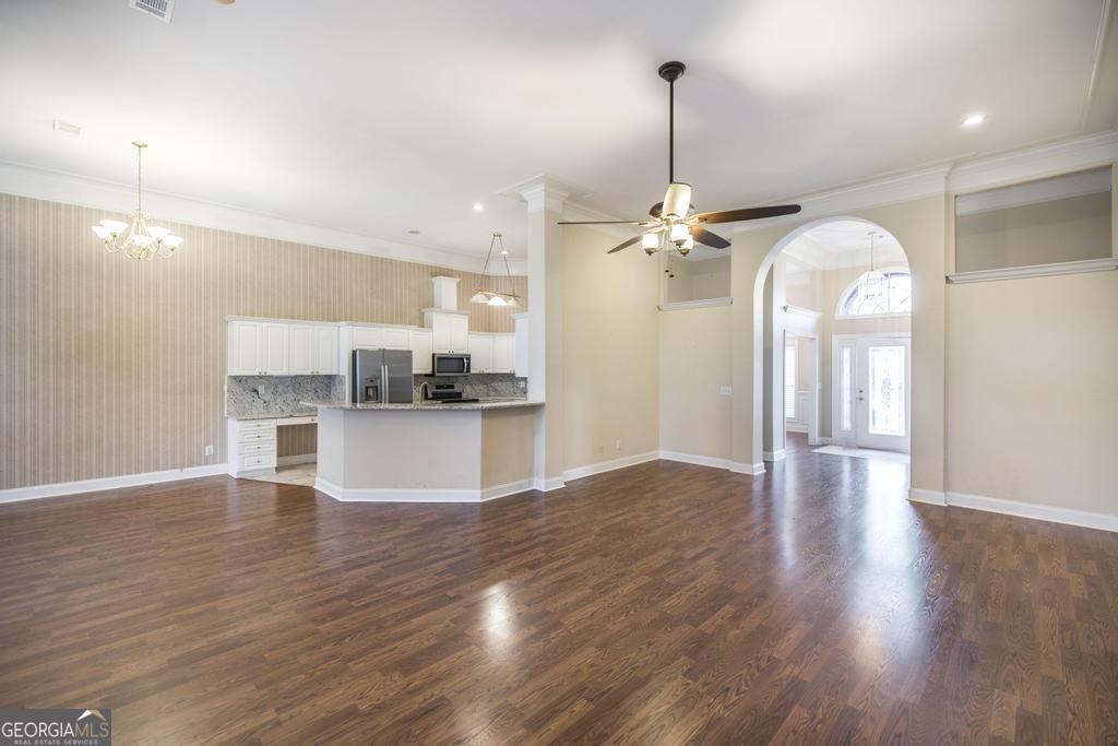 209 Trellis Walk Centerville, GA 31028 - Photo 15 of 38 a view of a kitchen with a refrigerator and wooden floor