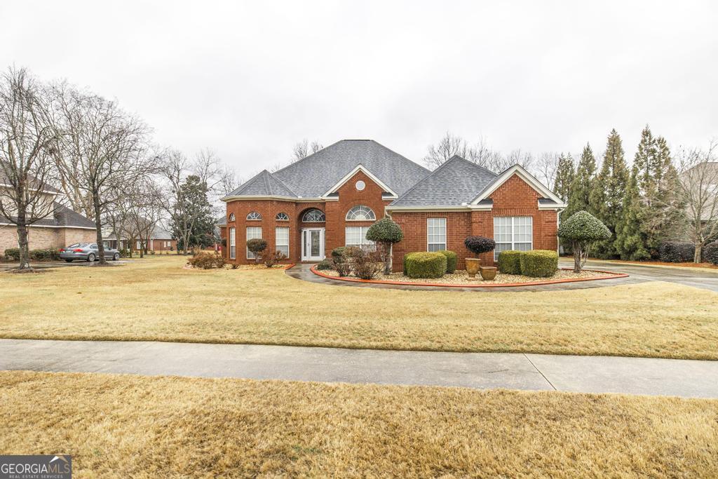 209 Trellis Walk Centerville, GA 31028 - Photo 2 of 38 a view of a houses with a yard and a large tree